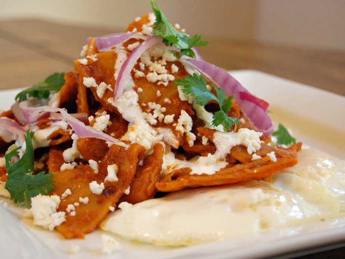 Corn tortillas are quartered, lightly fried, and cooked in either green, red, or mole salsa to make chilaquiles. Sometimes, the dish includes a poached egg on the side, but adding queso fresco and cream on top makes it out-of-this-world delicious.