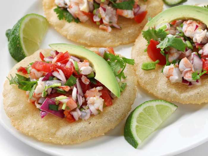 Tostadas are toasted corn tortillas commonly covered with ceviche made from fish, carrots, onion and lime. They pack a fresh, citrus-filled bite with a whole lot of crunch.