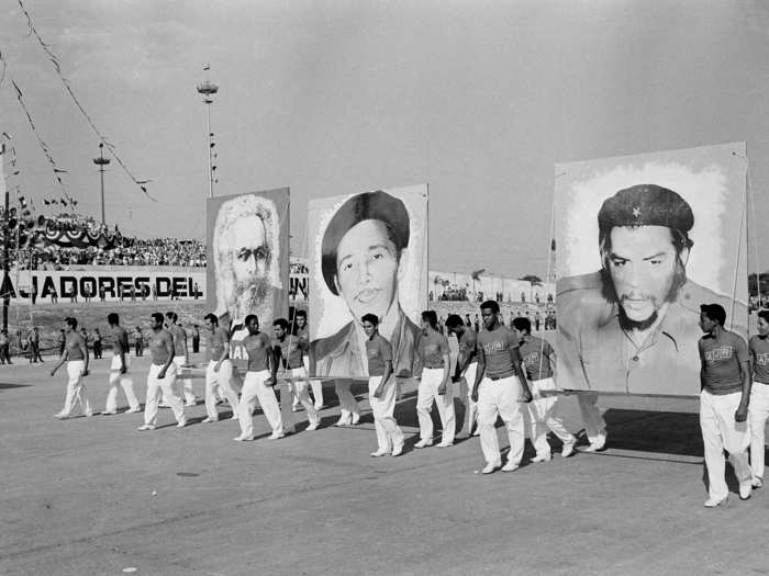 Cuban athletes carried portraits of Raul and Fidel Castro, along with an image of communist philosopher Karl Marx ...