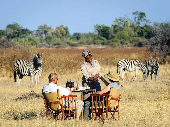 Eat breakfast while watching zebras at the Little Mombo Camp in Botswana