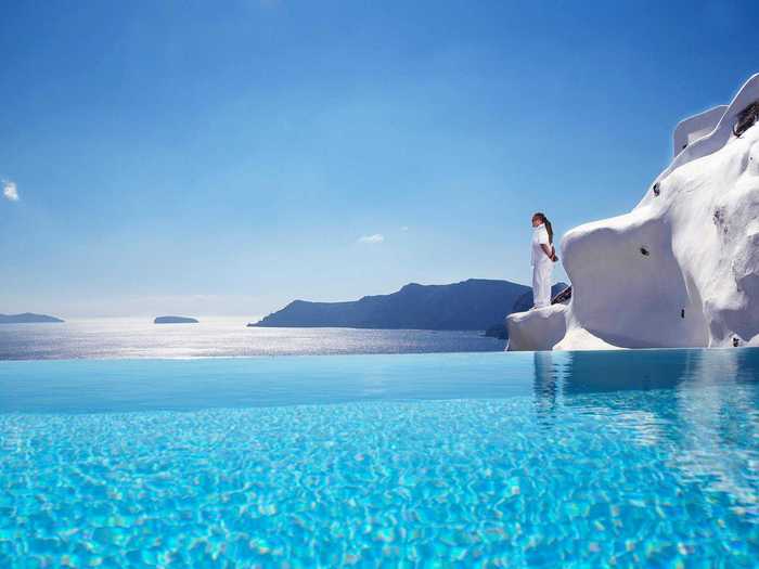 Take in the incredible views of the Mediterranean from each of the white picture-perfect villas of the Katikies Hotel in Oia, a town in the Greek island of Santorini.