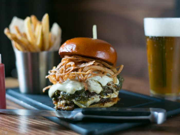 Pasadena, CA: The Chili Verde Prime Beef Burger is topped with slow-braised pork, jack cheese, and fried tobacco onions.