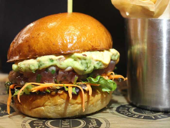 Irvine, CA: The Bánh Mi Tuna Burger combines a tuna tartare patty with guacamole, veggie slaw, and spicy mayo.