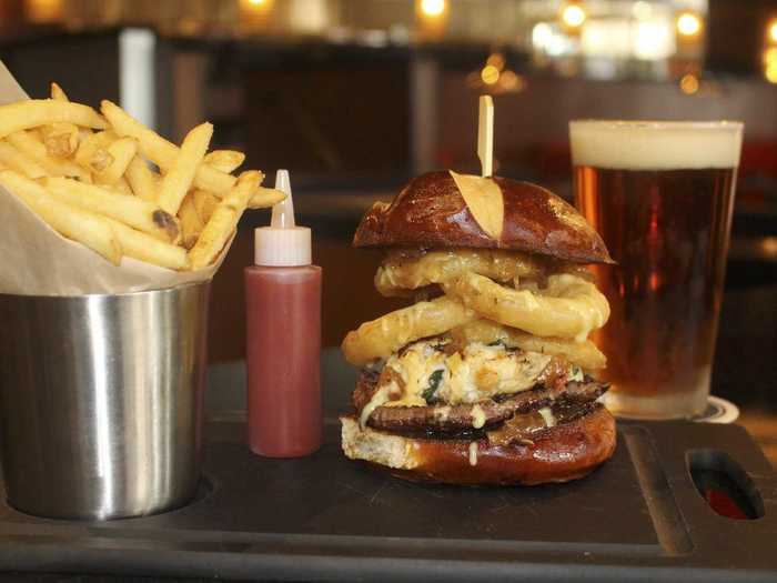 North Bethesda, MD: The Chesapeake Prime Burger is piled onto a pretzel roll with fried tobacco onions, a fresh crab cake, and honey-mustard sauce.