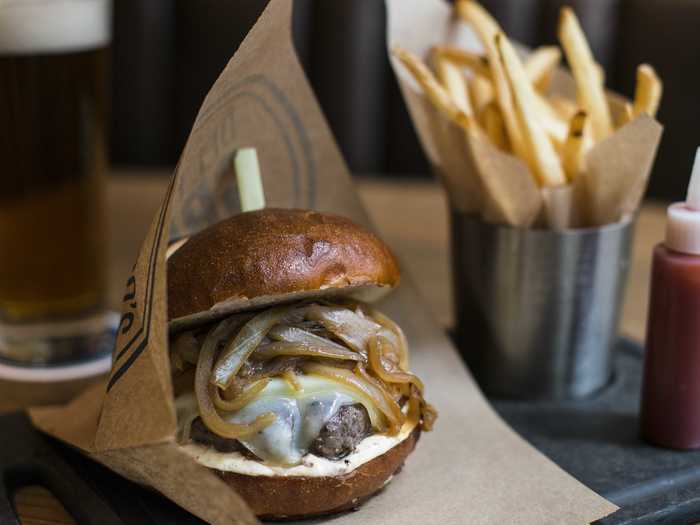 New York, NY: The Pretzel Burger combines an ample prime-beef patty with Captain Lawrence Brew caramelized onions, Swiss cheese, and mustard aioli.