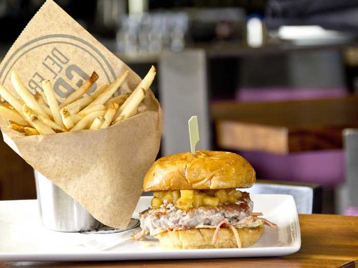 Palm Beach, FL: The Coastal Tuna Burger layers pineapple aioli, guacamole, and veggie slaw on top of a seared-tuna patty.