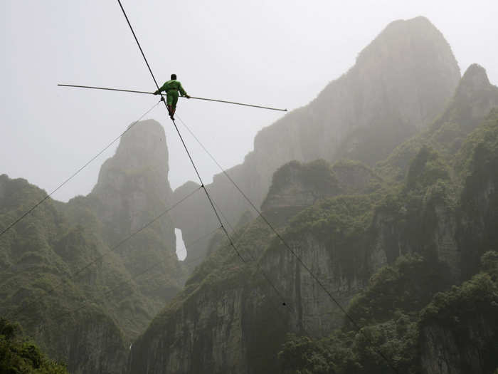 Samat Hasan, a 24-year-old stuntman from China, walks on a tightrope in Zhangjiajie, Hunan province April 25, 2009. Walking on a 2,300 ft rope with a 1.2 inches diameter and set at a 39-degree gradient, Hasan successfully broke the Guinness World Record for aerial tightrope walking after failing in a previous attempt in October the previous year, local media reported.