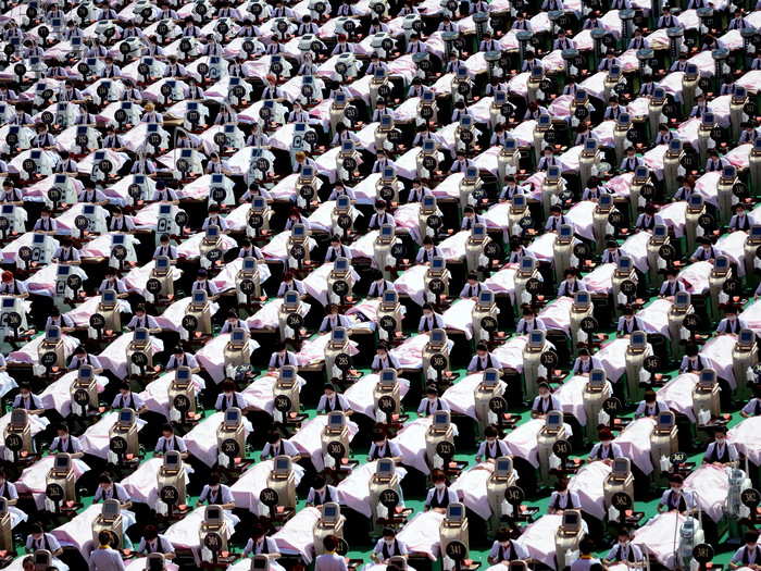 A group of 1,000 customers receive a facial massage at a sports center in Jinan, China, May 4, 2015. All women, the group was given a 30 minutes of facial beauty treatment together that achieved a Guinness record for the largest group of people having beauty treatment in the same location, according to local media.