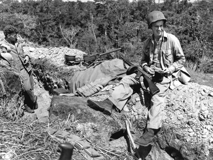 In the months following Pearl Harbor, Japanese forces expanded throughout the Western Pacific, prompting deployment of Marines to the tropical island of Guadalcanal. This 1943 photo shows two armed Marines waiting for “Chow Call,” or mealtime.