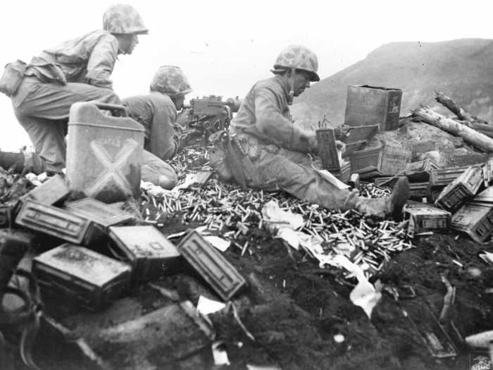 Iwo Jima was prime real estate for Americans to launch air raids against Japan, but the island was heavily guarded by Japanese forces. Amphibious Marines are seen here battling at the foot of Mount Suribachi.