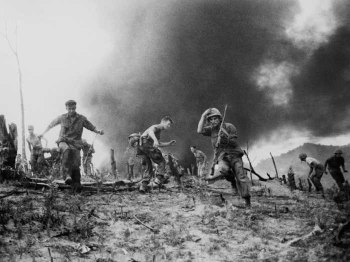 Marines scatter as a CH-46 helicopter explodes after it was shot down during combat in Vietnam. At least 13 Marines were reported killed in the crash and another  three more badly burned.