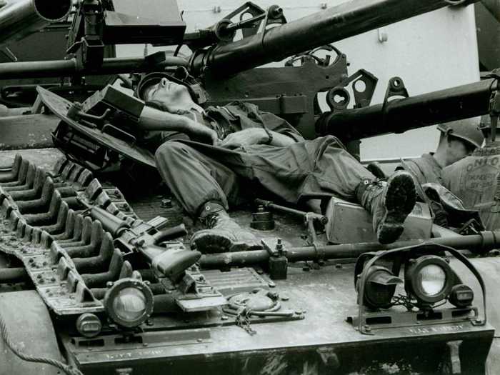 Here, an exhausted Marine takes a quick break from fighting atop a tank in Hue, Vietnam in 1968.