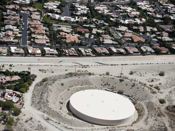 A parched water storage facility near homes in La Quinta.