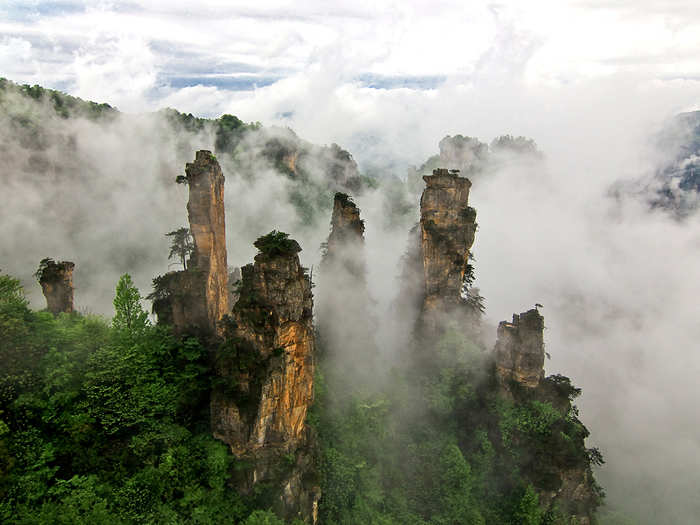 Tianzi Mountain Nature Reserve in Wulingyuan, China, contains "stone towers," surrounded by thick clouds, that appear straight out of "Avatar." It is one of the country