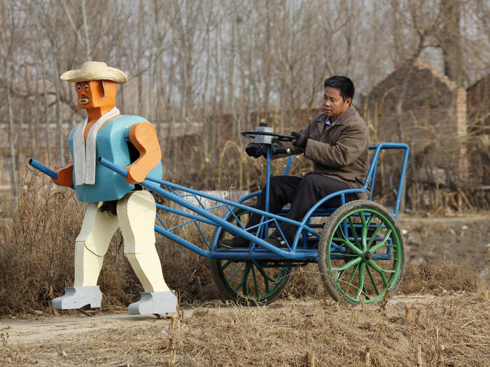 Farmer Wu Yulu started to build robots in 1986 and, by 2009, he unveiled this rickshaw that is being pulled by a robot.