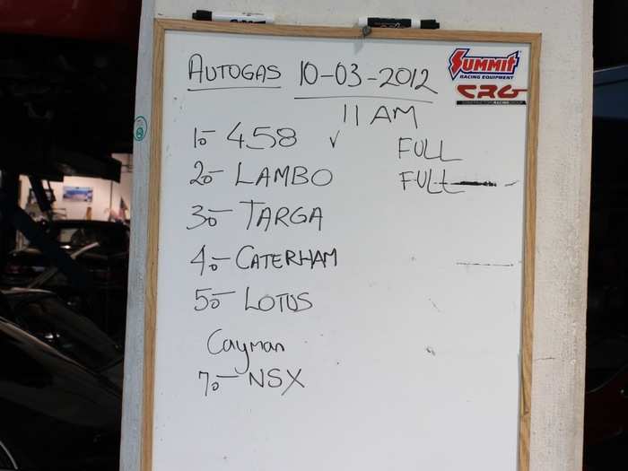 A whiteboard keeps track of the cars being used in that day