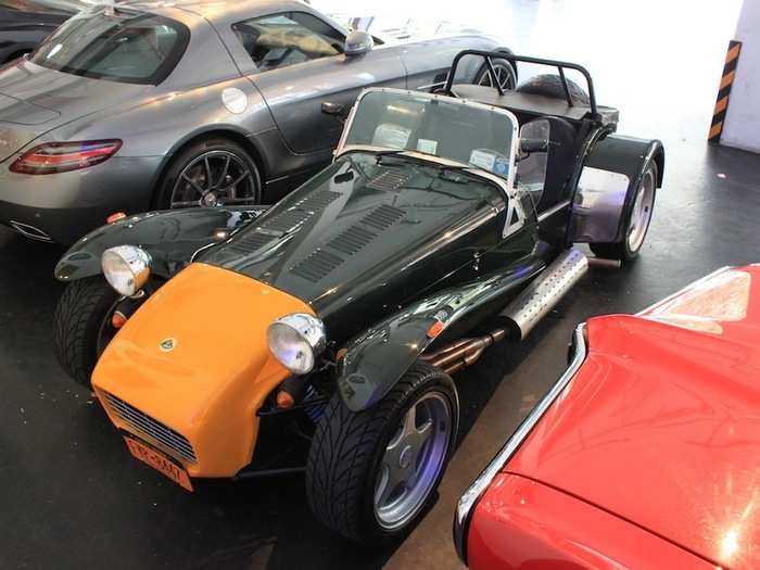Members wait for sunny days to drive the 1967 Caterham/Lotus Super 7. Next to it is a 2012 Mercedes SLS AMG.