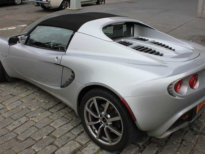 A Lotus Elise is parked on the corner.