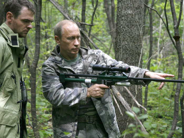 Or even tigers. Here he is with a tranquilliser gun as he visits the academy of sciences Ussuri reserve.