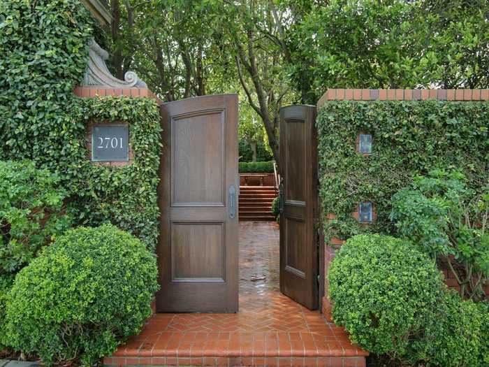 Enter the home through a door in an ivy-covered wall.