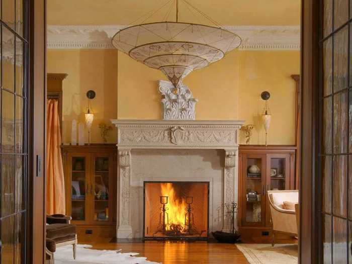 Ornate molding and a giant fireplace make for a dramatic entrance.