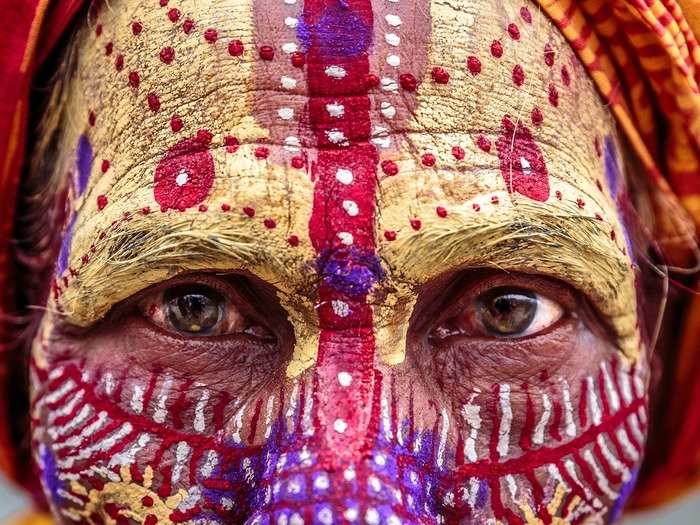 This man is an Aghori, a secretive Hindu sect of holy men known for eating corpses. They believe doing so will make them ageless and give them supernatural powers. The Aghoris are marked by colorful body paint and clothes.