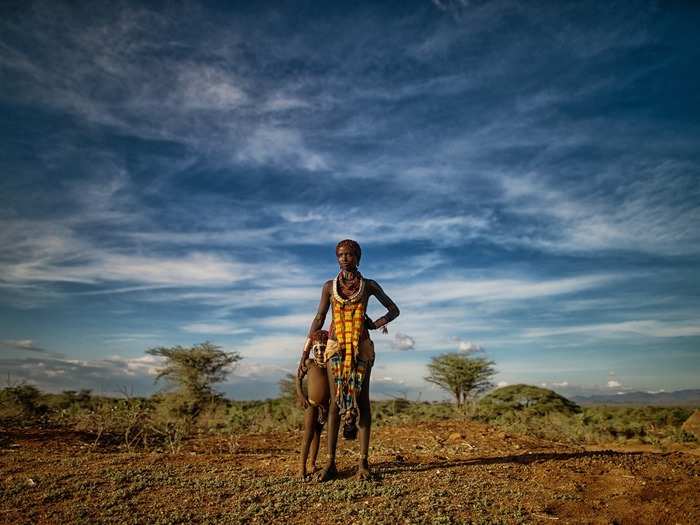 A Hamar woman and her son pose near a river in the Omo Valley of Ethiopia.