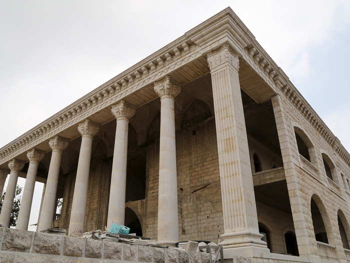 The village of Miziara prides itself on building residential homes in odd shapes. This house under construction imitates an ancient Greek temple like the one in Baalbek, eastern Lebanon.