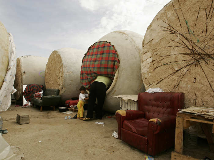 The homes in Socuellamos, central Spain, are all made from old wine vats. About 40 people, mostly ethnic Turks from Bulgaria who came to the vineyards of Socuellamos to pick grapes during the six-week annual harvest, live in this makeshift camp. At night, they sleep in 20 or so overturned wine vats, car-sized concrete barrels that were once discarded before finding a second life as shelter for the workers.