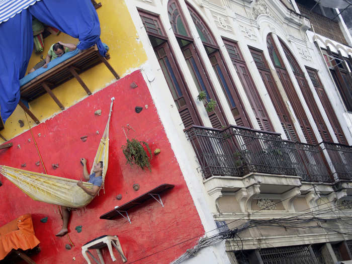 This house ensures its owners get their exercise in. Brazilian artists and brothers Tiago and Gabriel Primo built a vertical dwelling on the side of a climbing wall in downtown Rio de Janeiro.