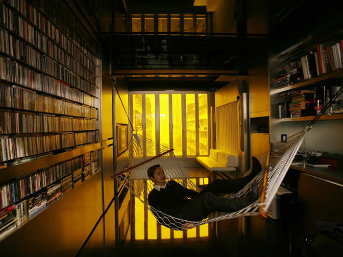 Hong Kong architect Gary Chang rests in a hammock inside his 330 square feet apartment in Hong Kong. After three decades in the same boxy dwelling Chang grew up in, he transformed the space into a eco-friendly and highly efficient space which utilizes moving walls to transform the space for various daily uses.