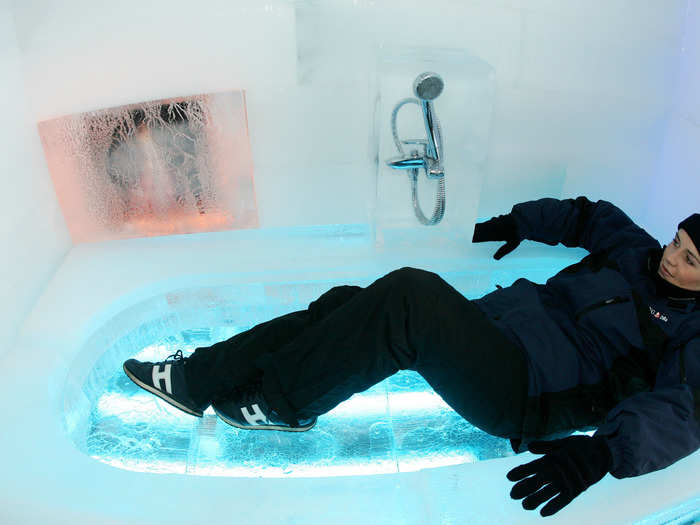 A model sits in an bathtub inside a house constructed entirely of ice as part of a promotion for a German bank in Berlin, 2005. The house was made of some 1,000 ice blocks, with all interior appliances, furnishings, and decoration encased within or made from ice.