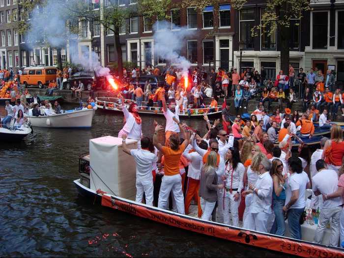 The streets of Amsterdam are filled with orange during Koninginnedag, also known as Queen