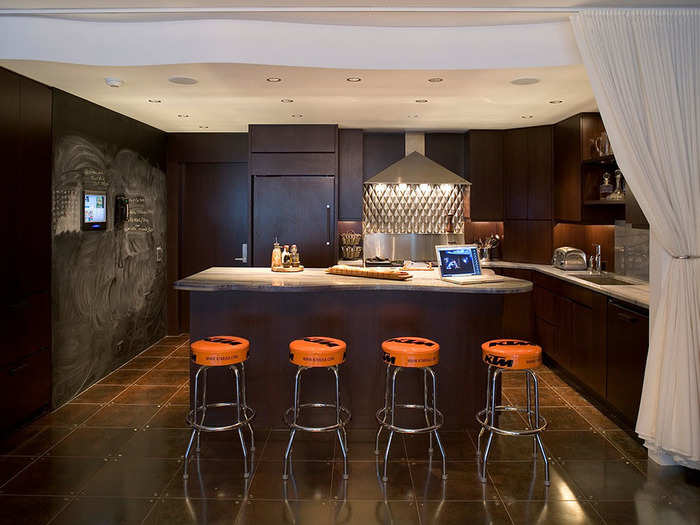 The kitchen has bar seating, a chalkboard wall, and huge counter space.