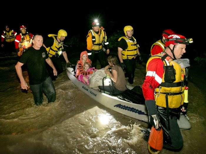 This lucky family was rescued by firefighters after clinging to a tree near their home in Kyle, Texas during flooding on Sunday.