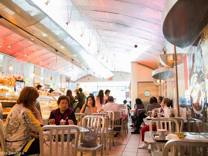 I stepped inside Tai Pan Bakery, a dreamy café with metal tables and chairs, pastel lighting, and a 20-foot buffet of pastries.