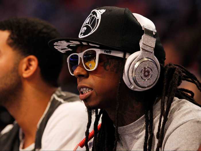 Rapper Lil Wayne sat courtside with his own custom Beats headphones, which appear to be the same pair that LMFAO infamously wore during their 2012 Super Bowl performance. Customized with 114 carats of diamonds by Graff Diamonds, they