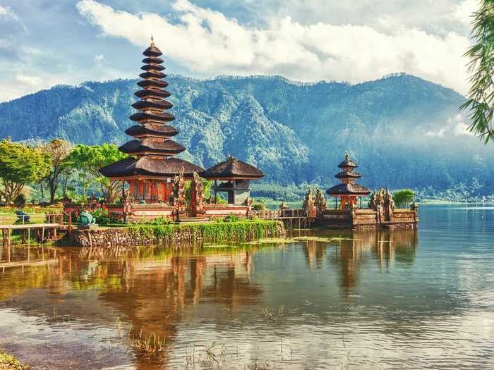 The Indonesian island of Bali is known for its traditional temples, lush green rice paddies, towering volcanic mountains, and beaches, making it a good destination for history buffs, beach bums, and outdoor-lovers alike.