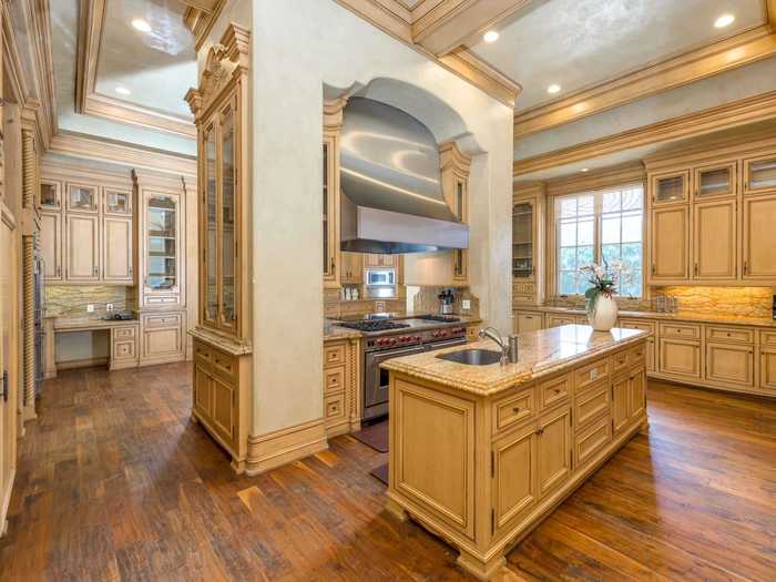 The kitchen is complete maze of intricate cabinetry, islands, and counter space galore.