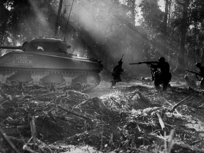 The Army also fought alongside the Marines in the Pacific against the Japanese. Here, infantrymen advance in the cover of an M4 Sherman tank on the Solomon Islands.