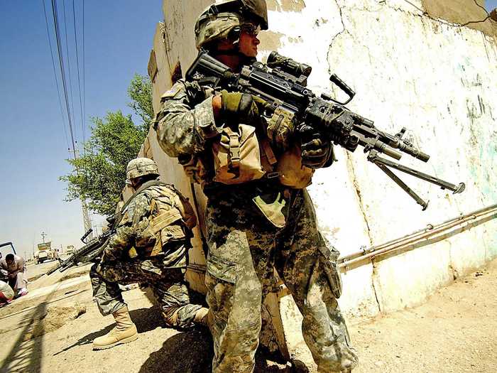 The Army has also functioned as a police force in war-torn areas. Two soldiers here provide security during a foot patrol in Ramadi, Iraq.