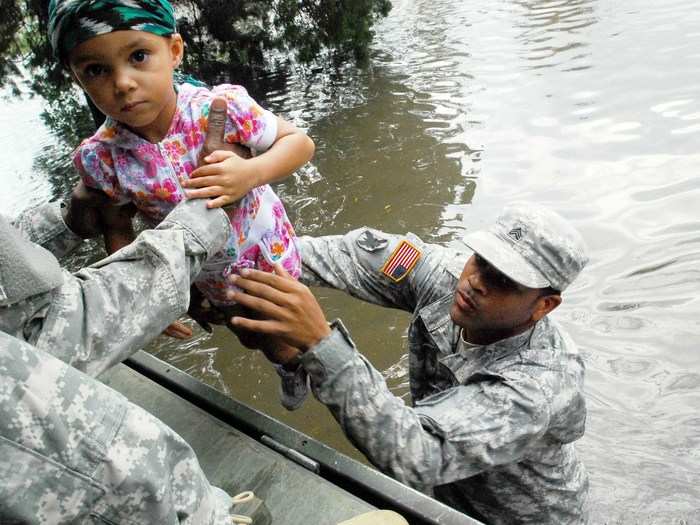 Members of the Army National Guard help serve in peacekeeping missions around the world, as well as aiding U.S. citizens caught up in natural disasters. A member of the Louisiana Army National Guard helps evacuate a child from flooding caused by Hurricane Isaac in 2012.