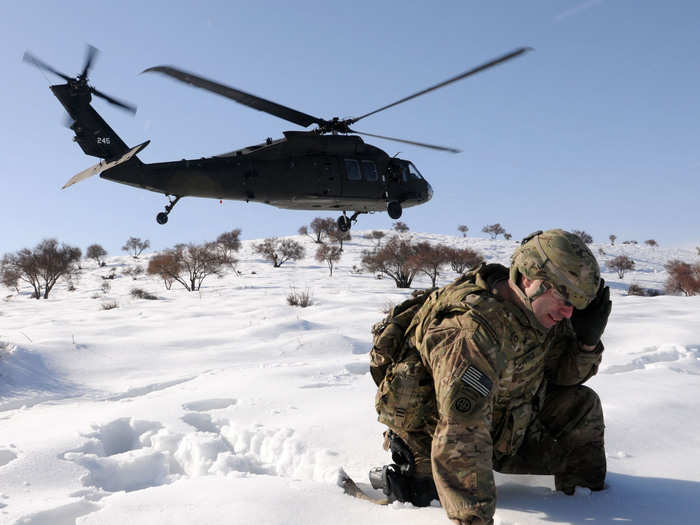 A Sikorsky UH-60 Black Hawk helicopter drops off a soldier. Black Hawks have been in service since 1979 and cost around $21.3 million.