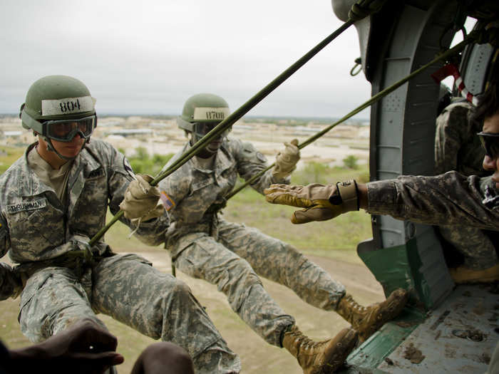 Soldiers practice repelling out of a Black Hawk helicopter at Fort Hood Air Assault School.