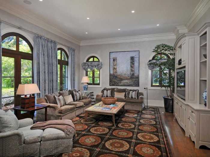 The family room boasts wood floors and plenty of natural light.