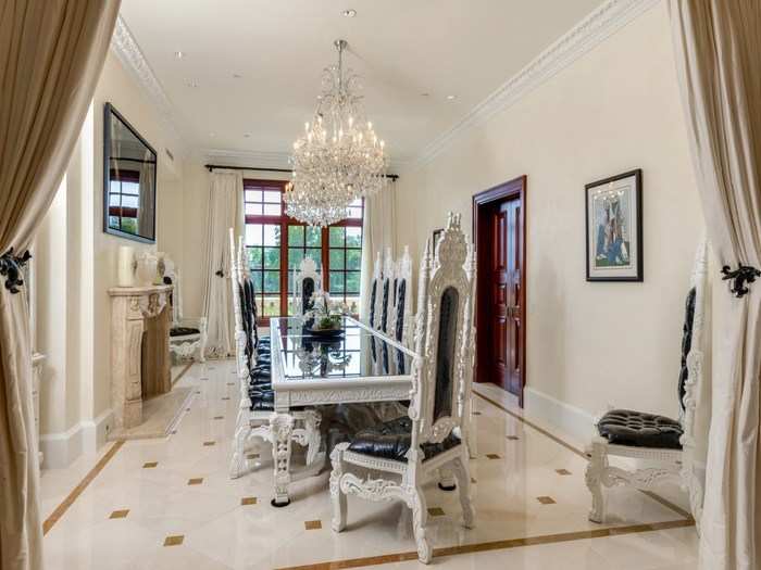 Off the kitchen, the formal dining room is as large as it is ornate.