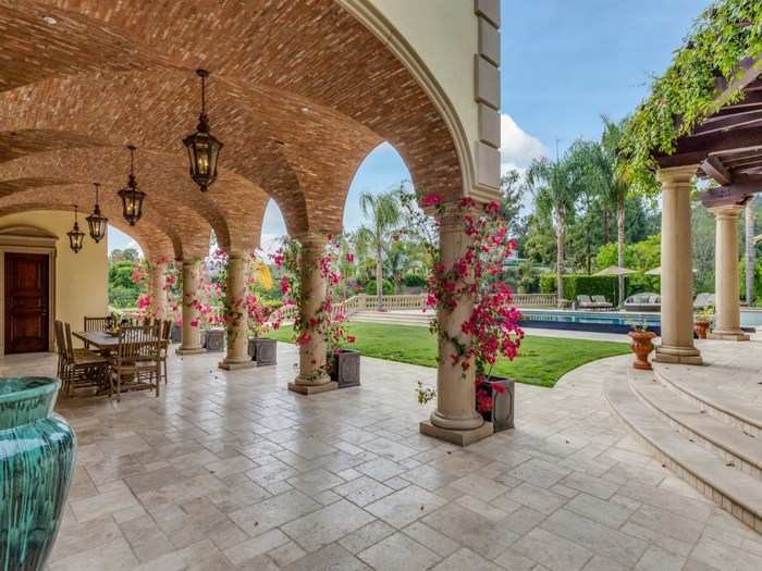 The backyard patio impresses with elaborate, brick-covered archways.