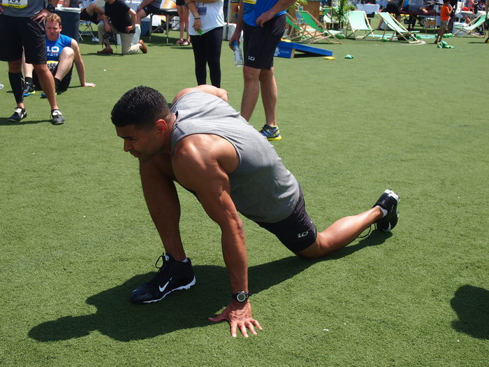 Citi associate Chris Owens stretches out before the 20 yard dash. He ran it in 4.56.