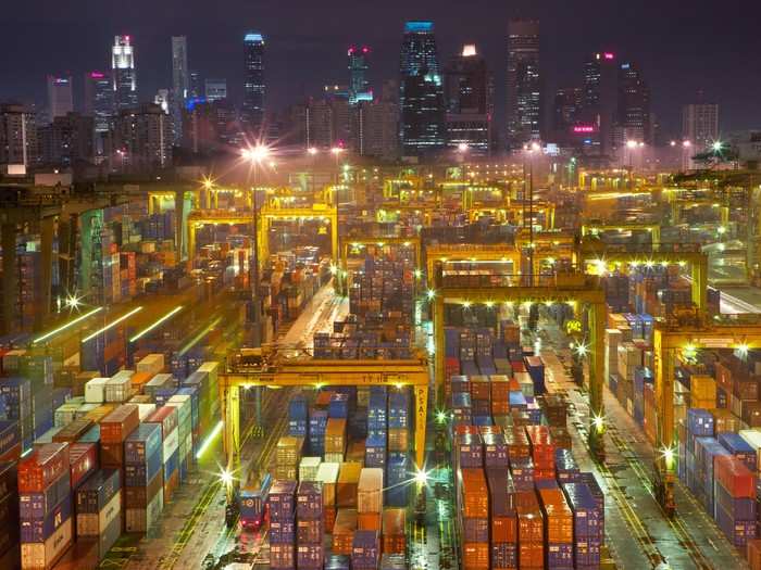 Shipping containers, indispensable tool of the globalized consumer economy, reflect the skyline in Singapore, the busiest transshipment port in the world and the second busiest in total shipping tonnage.