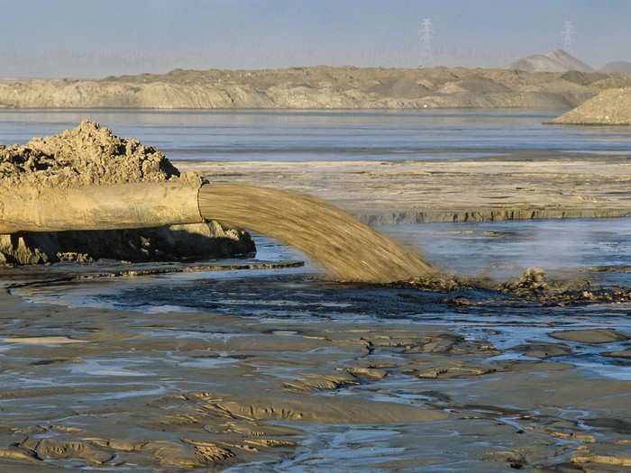 Tar-sands-related tailings ponds in the Athabasca Oil Sands area are among the largest collections of toxic materials on Earth and lie in unlined dikes feet from the Athabasca River. Indigenous communities downstream are fearful of being poisoned by toxic seepage into the food chain.